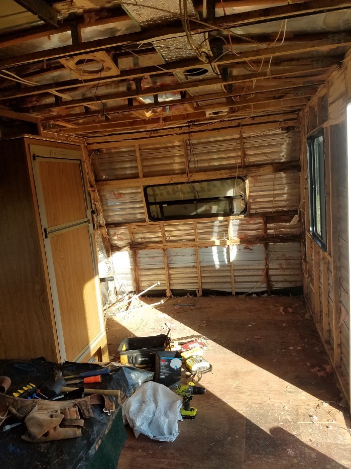 The interior of a travel trailer with walls and floor removed and cleaned up