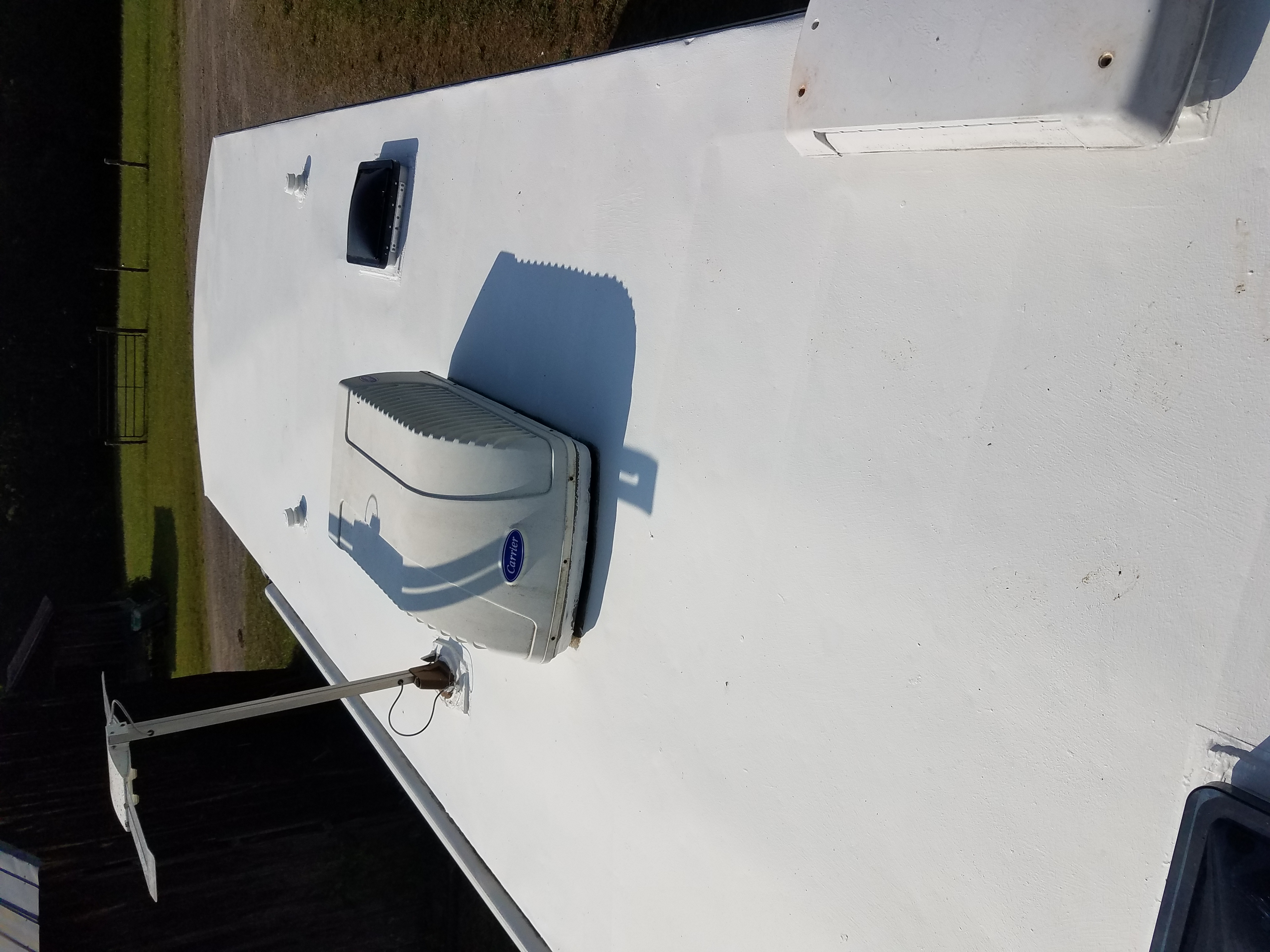 The roof of the travel trailer, freshly painted and white.