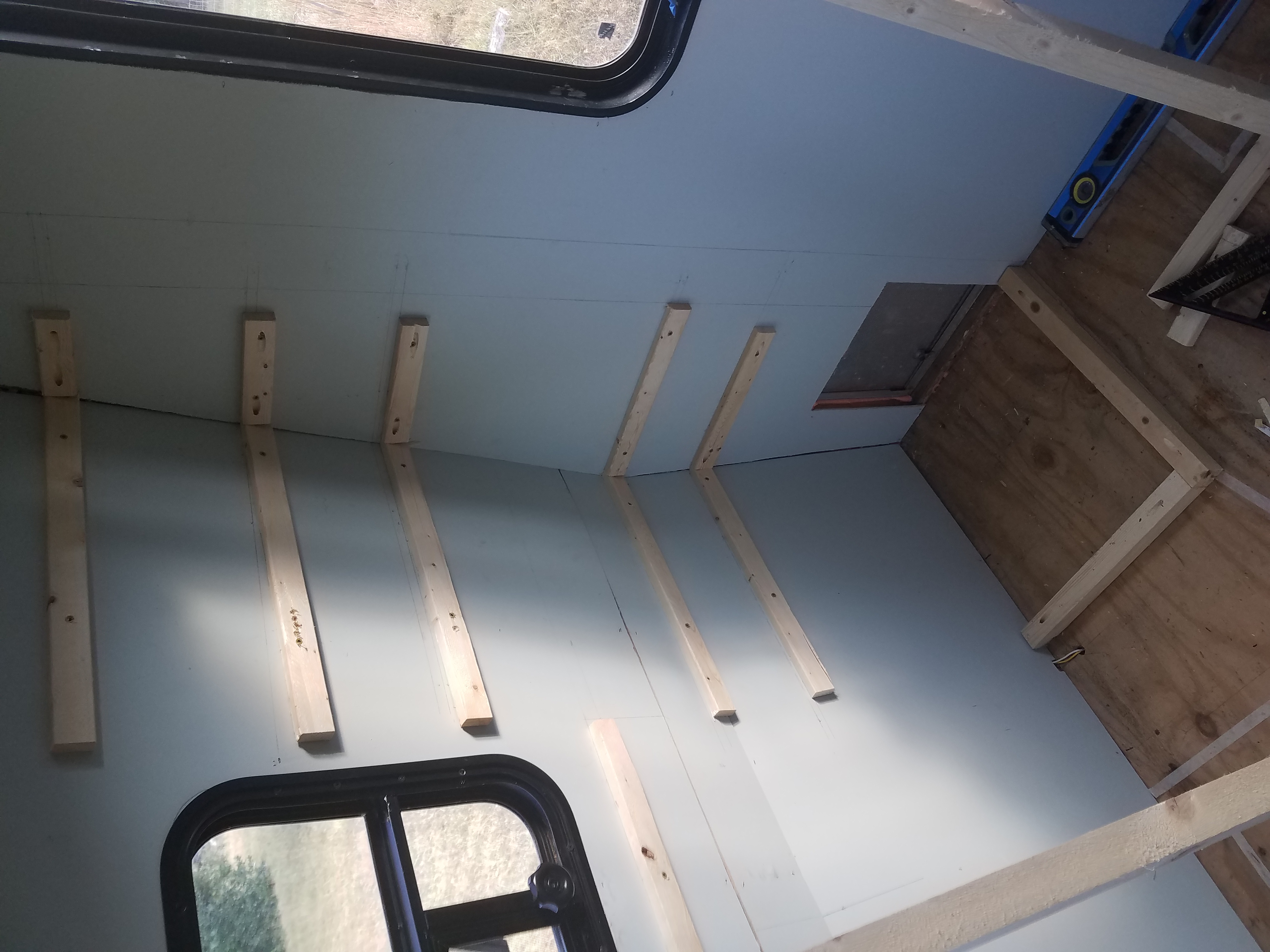 Bracing boards for the pantry shelving in the travel trailer kitchen