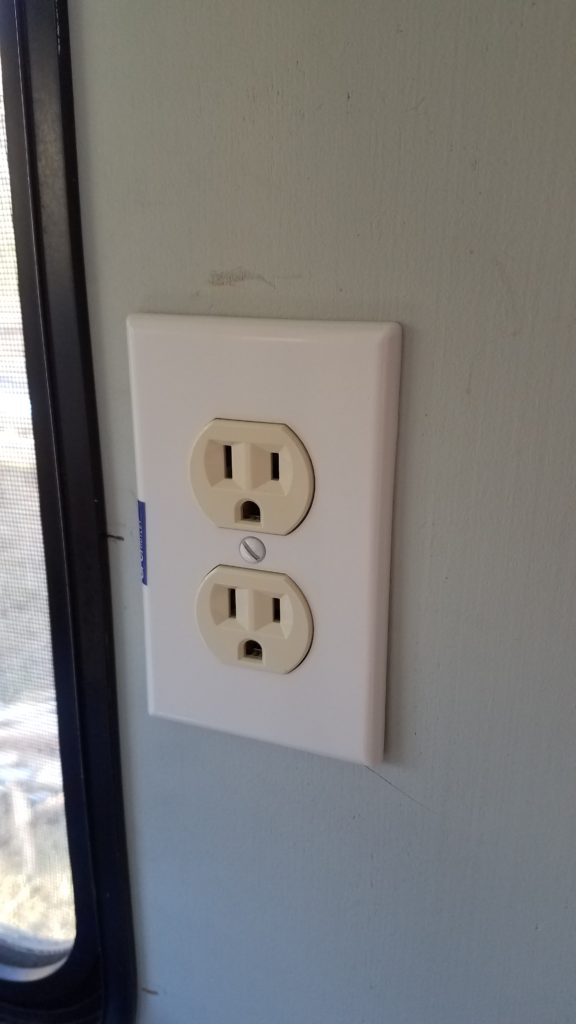 An outlet next to the window in the kitchen