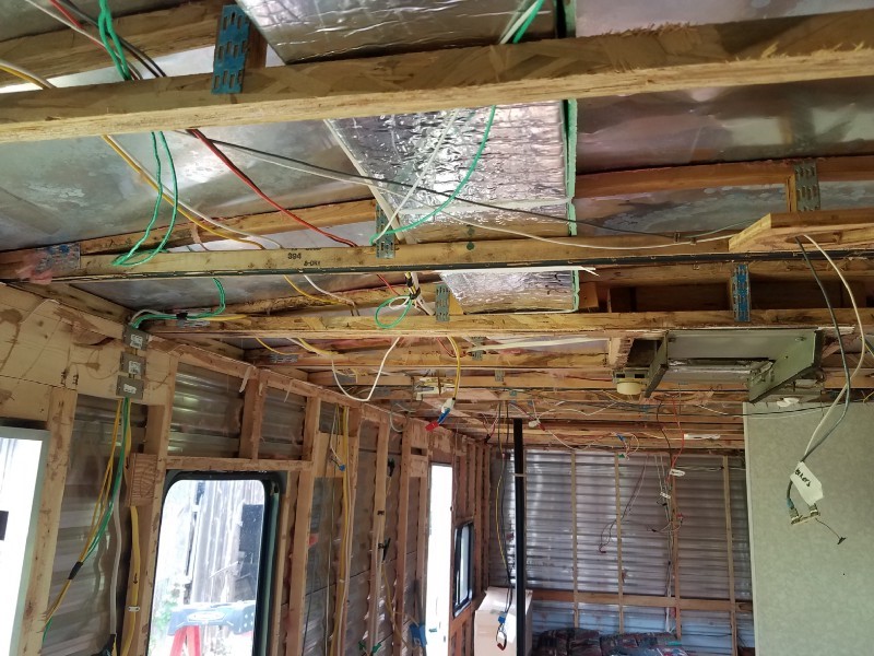 Inside of the travel trailer, wiring exposed in the stripped walls