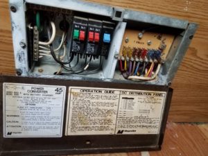 The coverter fuse box in the travel trailer opened to expose the fuses and wiring