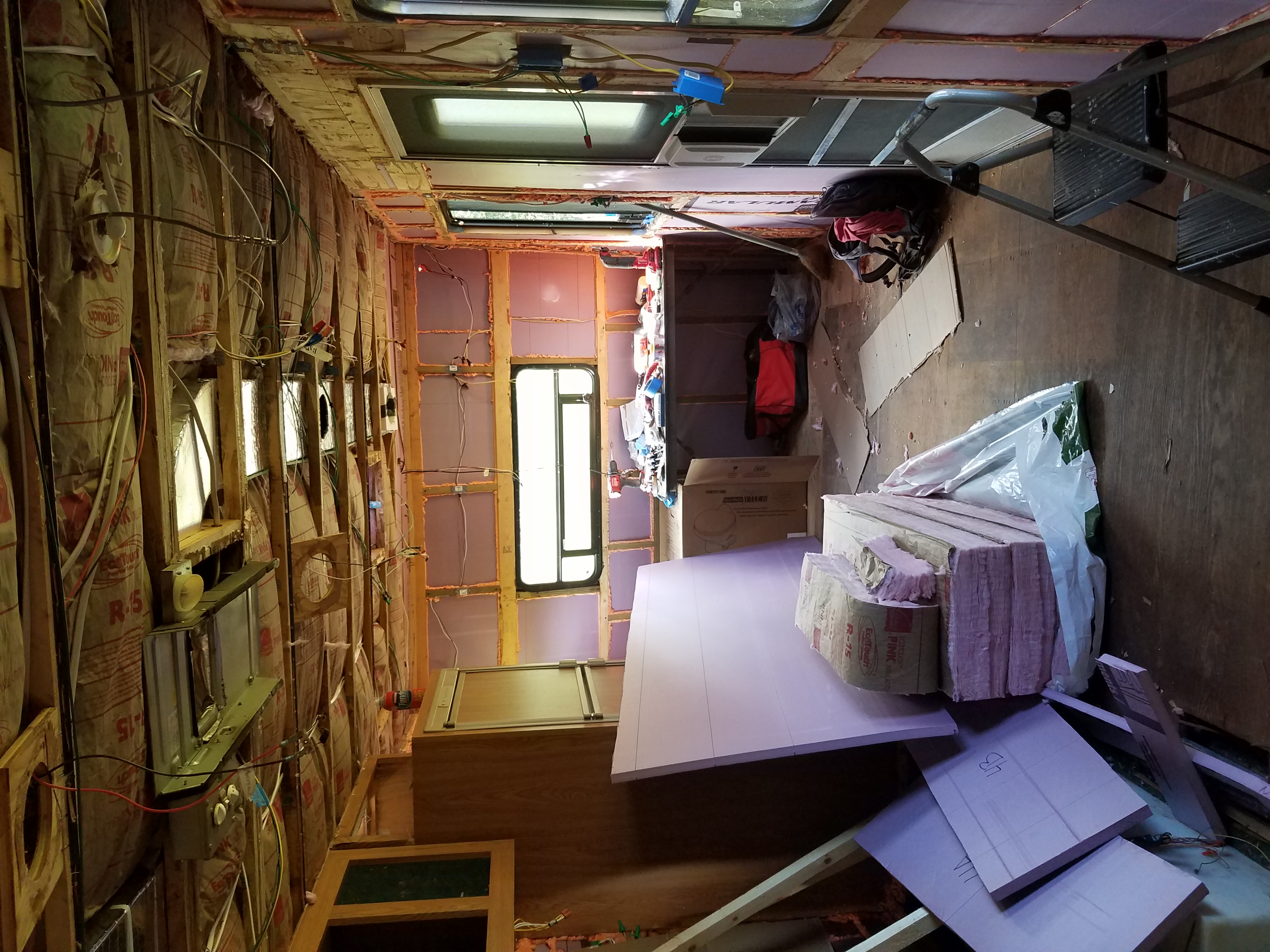 Interior of the travel trailer with insulation visible in the walls and ceiling.
