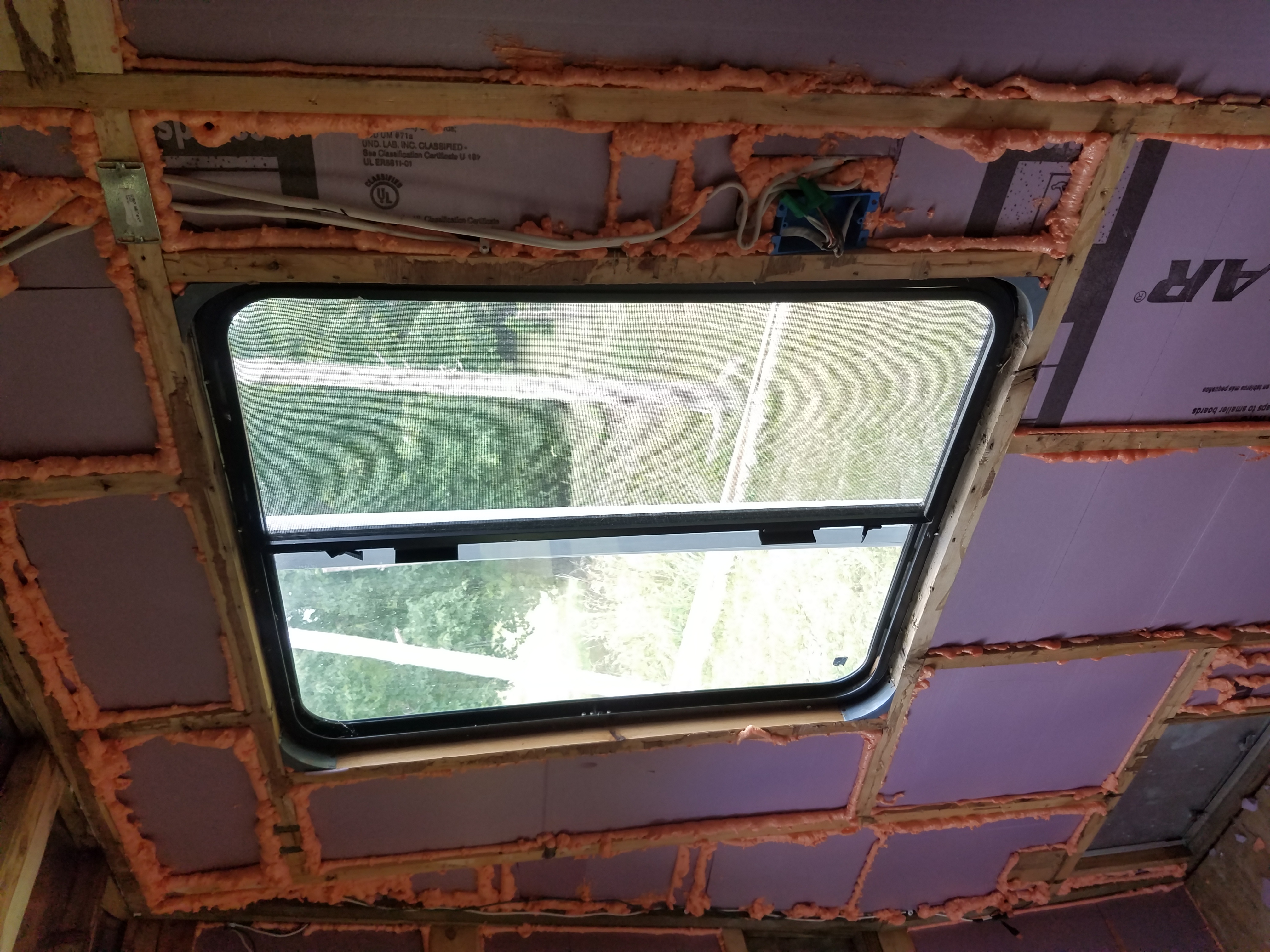 The inside of the trailer newly insulated with foam board and gap sealing foam