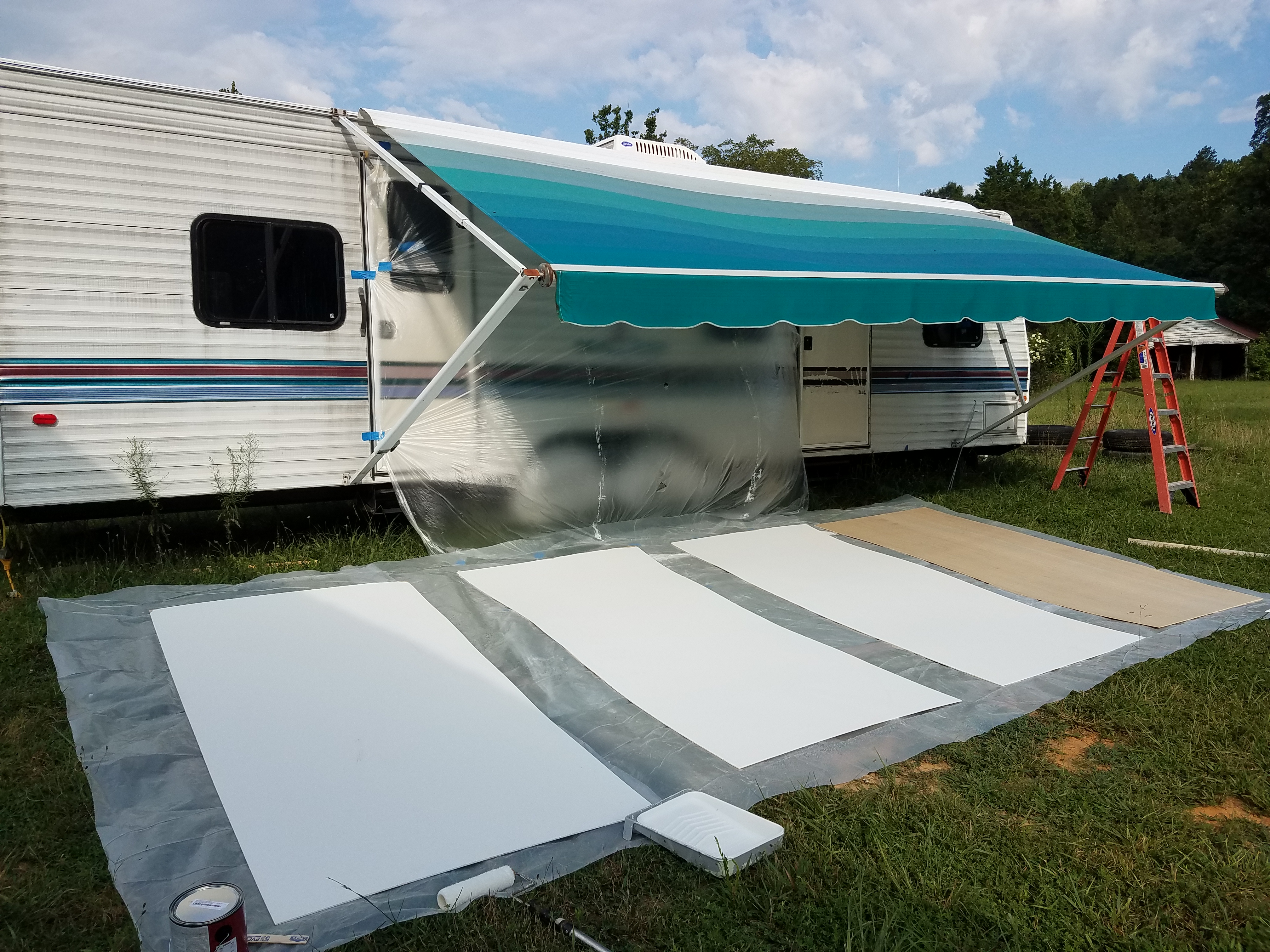 Painting primer on the wall panels for the travel trailer