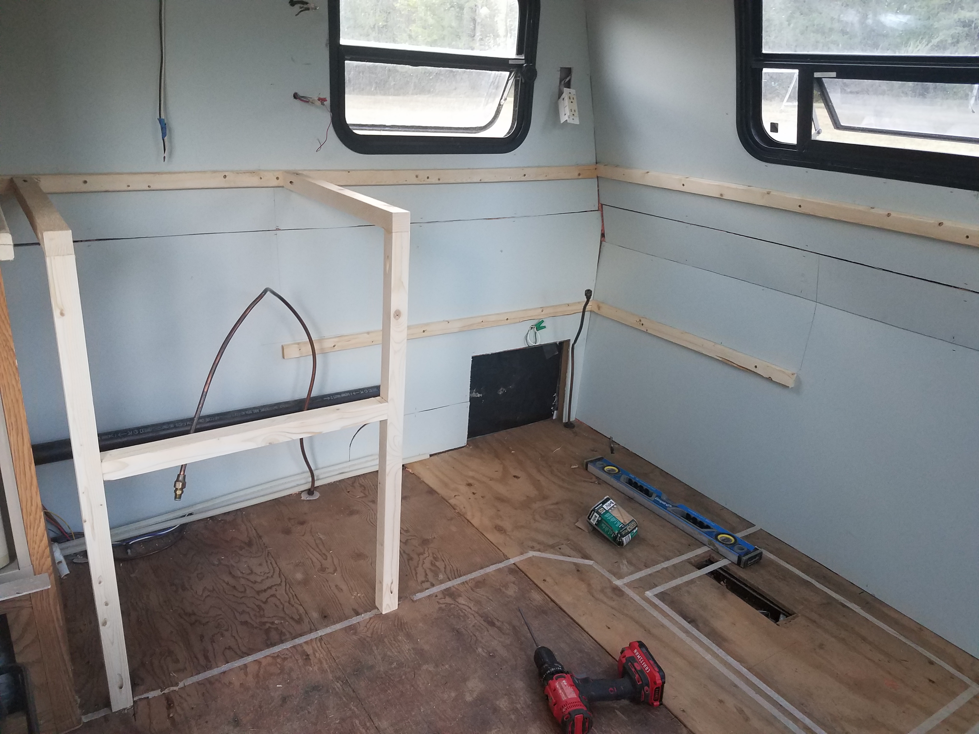 The frame of the stove in the kitchen of the travel trailer.