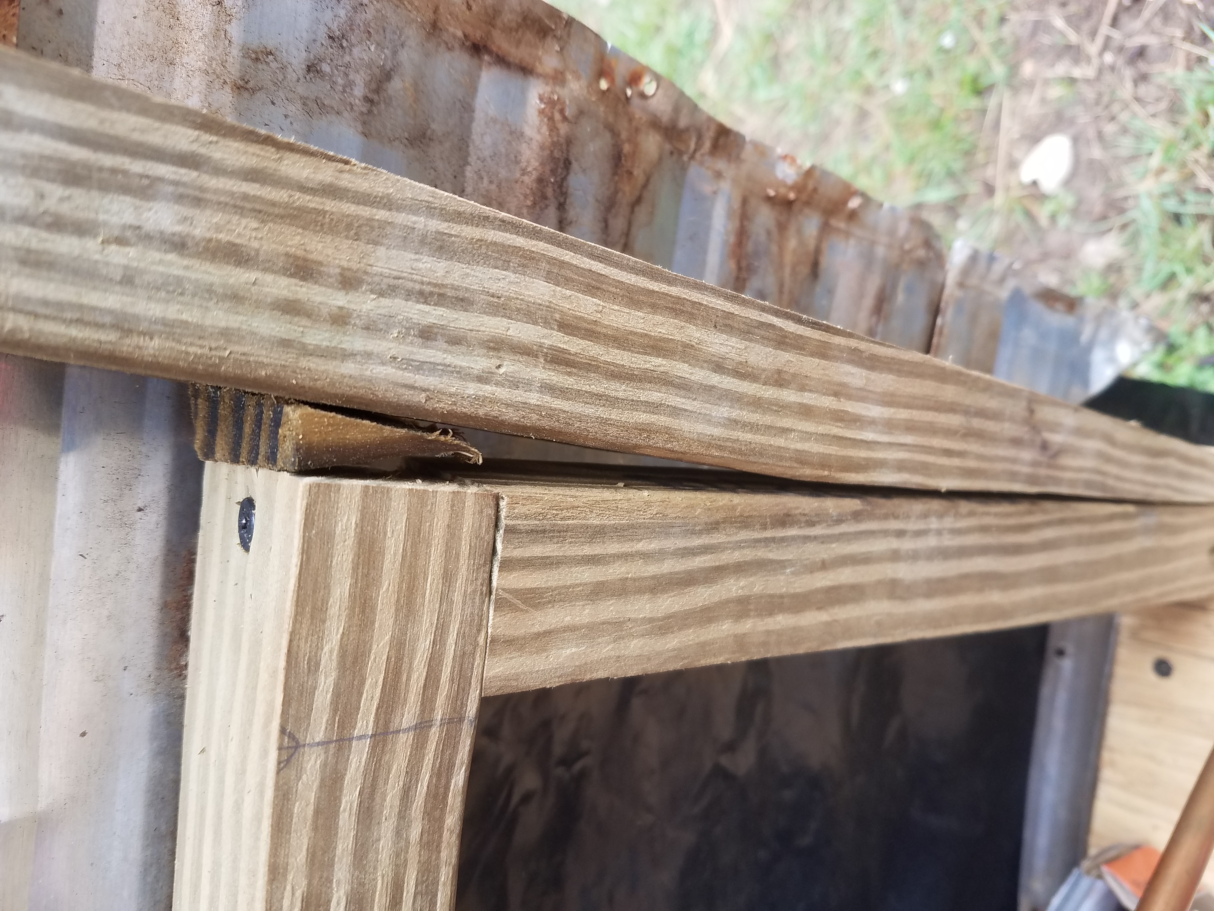 Framing of the travel trailer held together with a wooden wedge