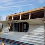 Front of the travel trailer with part of the siding removed.
