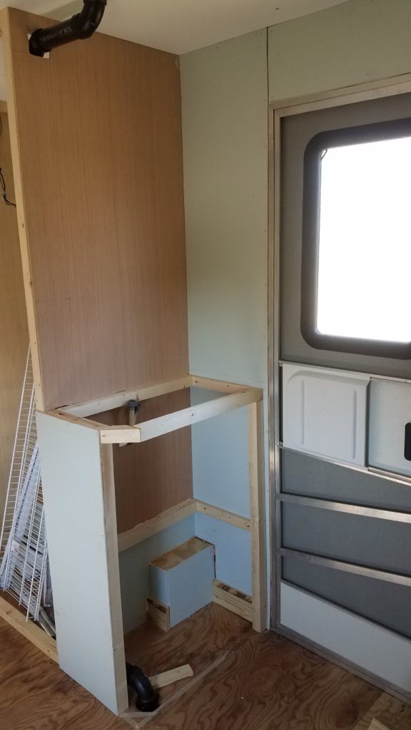 The interior of the travel trailer with the partially build bathroom sink